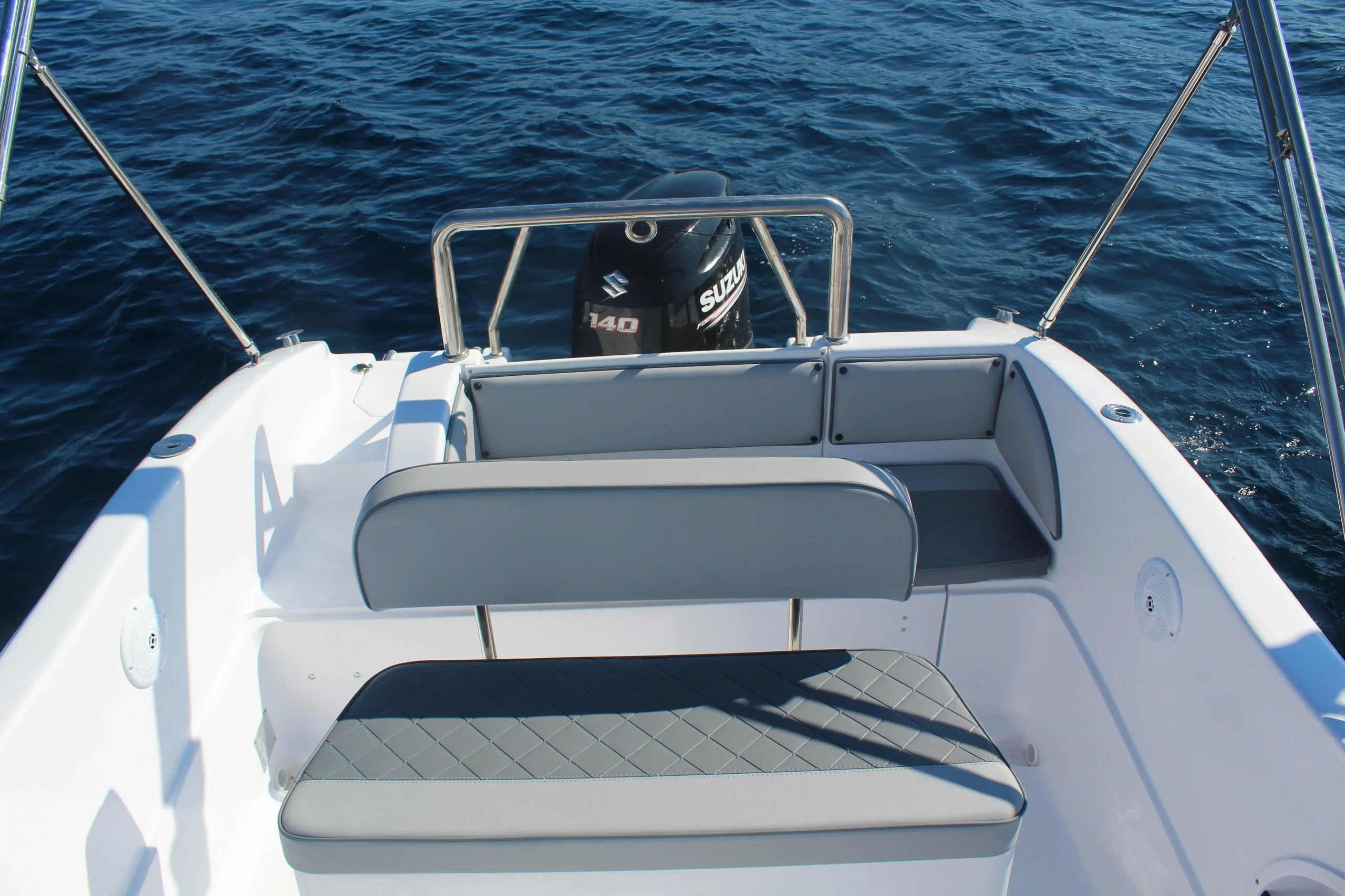 Rear seating area and Suzuki outboard engine of the Saver 19 rental boat